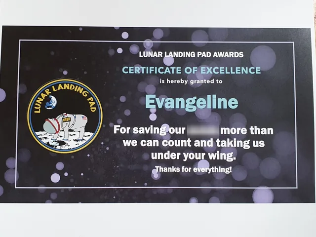 Lunar Landing Pad Awards certificate of excellence to Evangeline, for saving the team more times than they could count and taking them under her wing, with one word blurred. The team patch shows an astronaut dog on the Moon.