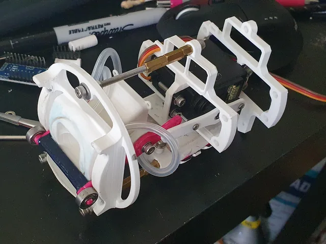 The second-generation bubble mechanism: a white 3D-printed assembly with a servo, bearings and a bubble ring.
