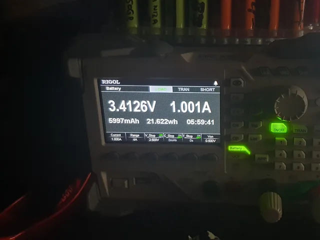 A Rigol electronic load in battery-test mode reading 5997 mAh and 21.6 Wh after a 1 A discharge.