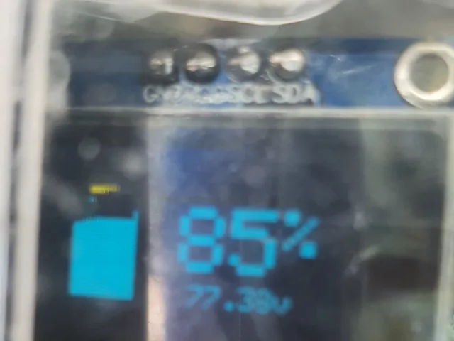 Close-up of the small dash display reading 85% charge and 77.38 V.